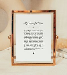 a poem written in black ink on a white card with a gold frame and a teddy bear