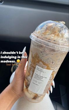 a person holding up a cup with food in it and the caption, i shouldn't be indulging in this madness