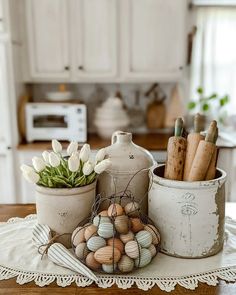 some pots with flowers and eggs in them on a table