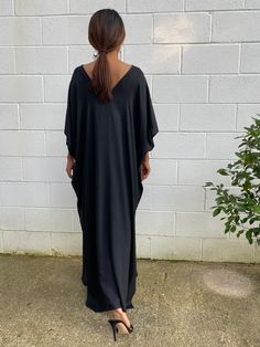 Celebrate your curves with our plus size kaftan dress. Created to embrace all body types, this kaftan is designed with care and style in mind. Its loose, flowing silhouette complements your figure while offering unbeatable comfort. The perfect choice for a night on the town or lounging at home. Black Long Maxi Dress For Loungewear, Black Maxi Dress For Loungewear, Chic Black V-neck Kaftan, Black Flowy Maxi-length Kaftan, Flowy Black Maxi Length Kaftan, Casual Black Kaftan With Kimono Sleeves, Black V-neck Kaftan For Loungewear, Black Maxi Length Thobe For Summer, Black Summer Thobe Maxi Length