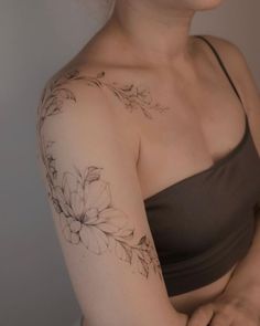 a woman with a flower tattoo on her arm