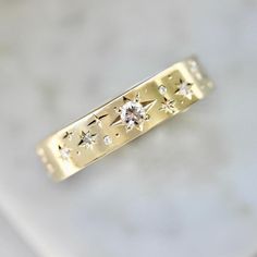 a gold ring with stars on it