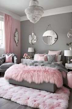 a bedroom decorated in pink and grey with fur rugs on the floor, chandelier