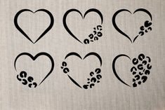 six hearts with paw prints are shown in black ink on a white linen fabric background