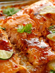 a close up of food on a plate with limes and cilantro leaves