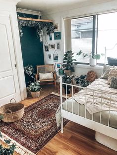 a bed room with a neatly made bed and a rug on the floor next to it