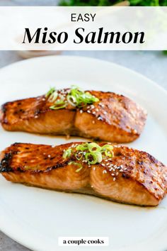 two pieces of salmon on a white plate