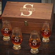 three glasses sitting on top of a table next to a wooden box