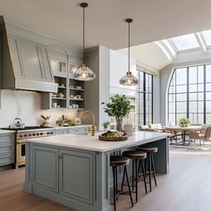 a large kitchen with an island in the middle and lots of counter space on one side