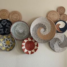 several woven baskets are hanging on the wall