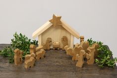 a wooden nativity scene with figurines in the foreground