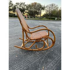 a wooden rocking chair sitting on top of a parking lot