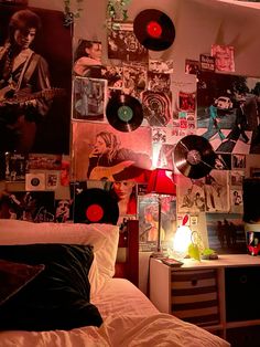 a bedroom with lots of records on the wall