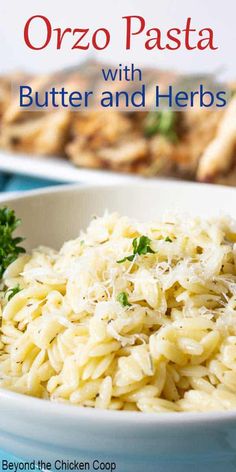 a white bowl filled with pasta and parsley on top of a blue table cloth