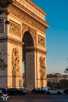 cars are parked in front of the arc de trio triumphe, which is also known as the arch of triumph