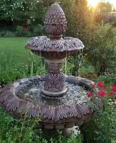 a water fountain in the middle of a garden