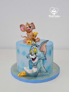 a blue cake with cartoon characters on it