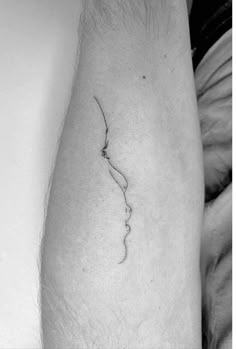 a black and white photo of a person's leg with a tattoo on it