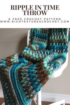 a crocheted blanket sitting on top of a white chair