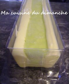 a cake in a plastic container sitting on a counter with the words ma cuisine du dimanche