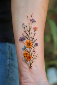 a woman's arm with flowers and butterflies on it