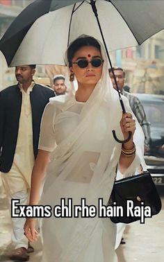 a woman walking down the street with an umbrella over her head and text that reads exam chhre hain raja