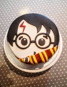 a birthday cake with a harry potter character on it's face and striped tie