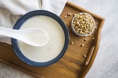 a bowl of cereal and a spoon on a tray