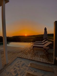 the sun is setting over an empty deck