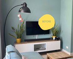 a flat screen tv sitting on top of a wooden entertainment center in a living room