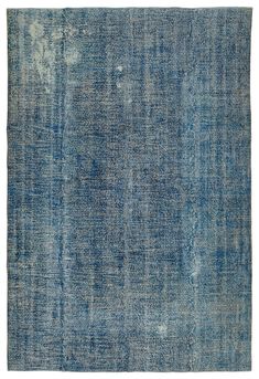 an old blue rug with faded edges