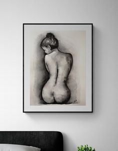 a black and white painting on the wall above a bed