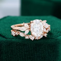 a diamond ring sitting on top of a green cloth