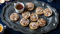 small pastries on a tray with tea and candles