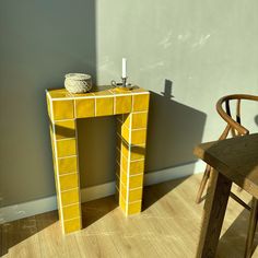 a small yellow table sitting next to a chair