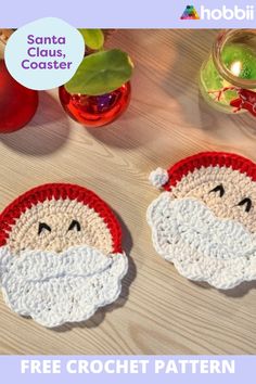 two crocheted santa claus coasters on a table