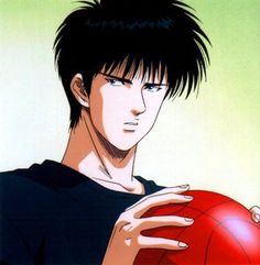 a young man holding a red ball in his hands