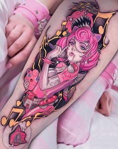 a woman with pink hair and tattoos on her leg