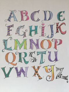 the letters and numbers are drawn with colored pencils on white paper, which has been placed