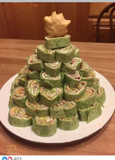 a christmas tree made out of rolls on a plate