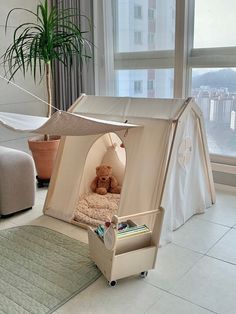 a child's bed with a teddy bear in it