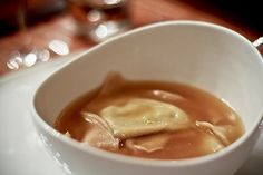 a white bowl filled with soup on top of a table