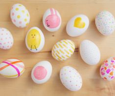 an assortment of painted eggs on a wooden surface