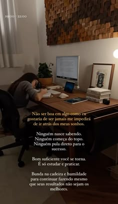 a woman sitting at a desk in front of a computer