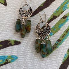 Temple Link Antique Silver Plated Hardware With Picasso Green Spindle Beads. Earrings Measure 2” Silver Beaded Earrings With Czech Glass, Silver Dangle Earrings With Czech Glass, Silver Teardrop Beaded Earrings Bohemian Style, Bohemian Silver Teardrop Earrings With Dangling Beads, Bohemian Silver Teardrop Beaded Earrings, Green Bohemian Beaded Earrings In Sterling Silver, Bohemian Sterling Silver Teardrop Beaded Earrings, Bohemian Green Beaded Sterling Silver Earrings, Gold Bead Earrings