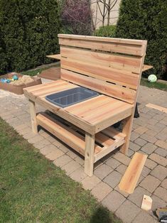 a wooden bench sitting on top of a brick walkway