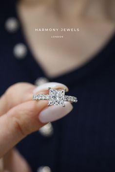 a woman holding a diamond ring in her hand