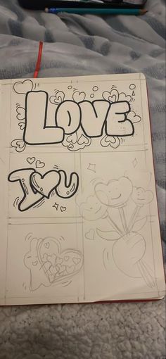 an open notebook with the word love drawn on it and some other doodles next to it