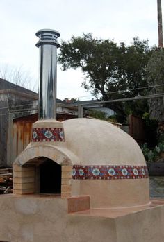 an outdoor pizza oven in the middle of a yard