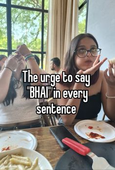 a woman sitting at a table with food in front of her and the caption reads, the urge to say bhaj in every sentence